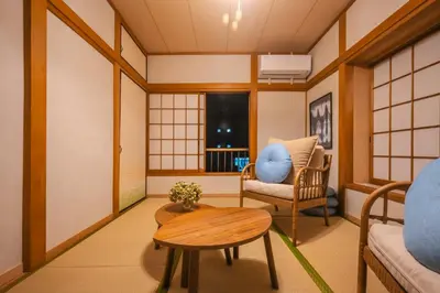 a japanese room with a chair and a table at Japandi House Haneda in Tokyo