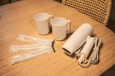 a table with two cups and some items on it at Japandi House Haneda in Tokyo