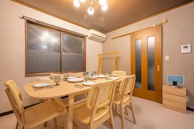 a dining room with a wooden table and chairs at Japandi House Haneda in Tokyo