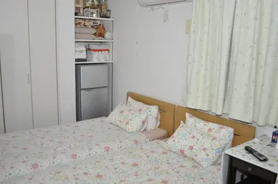 a bedroom with a bed and pillows on it at Sunny moe oo in Tokyo