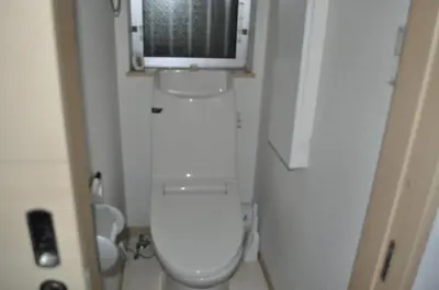 a small bathroom with a toilet with a tv on top at Sunny moe oo in Tokyo