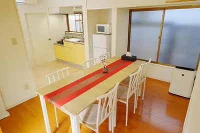 a kitchen and dining room with a table and chairs at LARGE HOUSE Lodging Hidamari in Tokyo