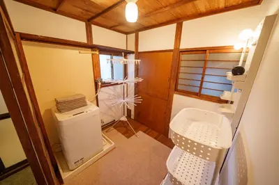 a small bathroom with a toilet and a sink at LARGE HOUSE Lodging Hidamari in Tokyo
