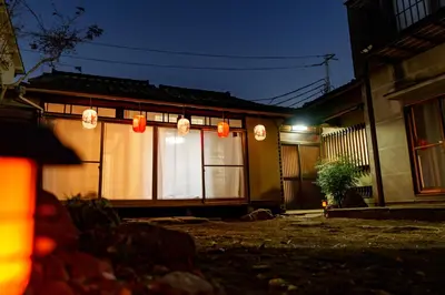 a house with lights in front of it at night at LARGE HOUSE Lodging Hidamari in Tokyo