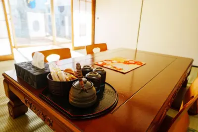 a wooden table with food on top of it at LARGE HOUSE Lodging Hidamari in Tokyo