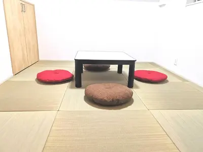 a coffee table and three rugs on the floor at KIK HOUSE-Self Check in- Will send room number and password in Tokyo