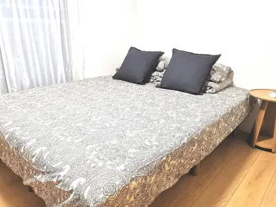 a bed with two pillows on it in a room at KIK HOUSE-Self Check in- Will send room number and password in Tokyo
