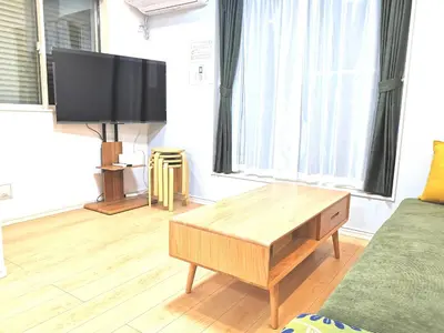a living room with a tv and a coffee table at KIK HOUSE-Self Check in- Will send room number and password in Tokyo