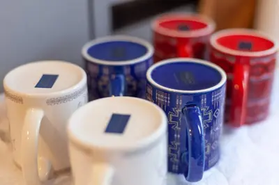 a group of blue and white cups on a table at \u30e9\u30d3\u30c8\u30f3\u30d3\u30eb in Tokyo
