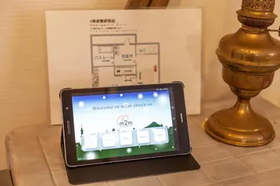 a tablet computer sitting on a table next to a lamp at \u30e9\u30d3\u30c8\u30f3\u30d3\u30eb in Tokyo