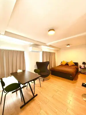 a bedroom with a bed and a table and chairs at home shinjuku west301 in Tokyo