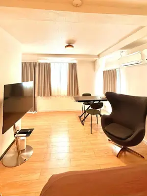 a large living room with a table and a chair at home shinjuku west301 in Tokyo