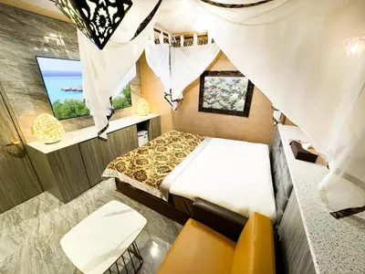 a small room with a bed and a window at Hotel BaliBali \u9daf\u8c37 in Tokyo