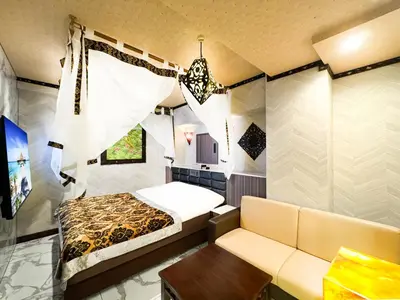 a small room with a bed and a couch at Hotel BaliBali \u9daf\u8c37 in Tokyo