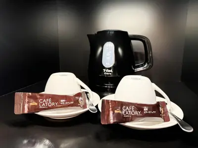 a black table with two plates and a coffee mug at Hotel BaliBali \u9daf\u8c37 in Tokyo