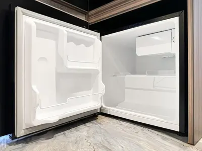 an empty refrigerator with its door open in a kitchen at Hotel BaliBali \u9daf\u8c37 in Tokyo