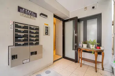 a room with a door and a table with plants at KYARA HOTEL \u4e80\u6238a in Tokyo