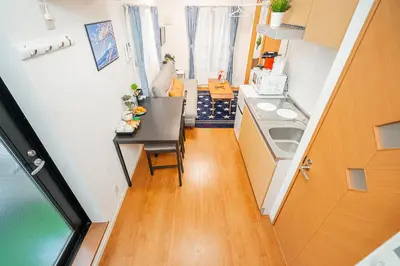 a small kitchen with a table and a sink at KYARA HOTEL \u4e80\u6238a in Tokyo