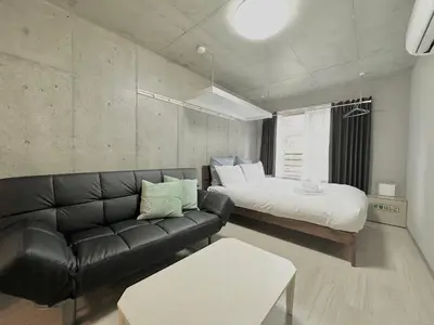 a living room with a couch and a bed at Hotel \u30de\u30fc\u30d9\u30e9\u30b9Asakusa #1 in Tokyo
