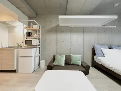 a living room with a bed and a couch at Hotel \u30de\u30fc\u30d9\u30e9\u30b9Asakusa #1 in Tokyo