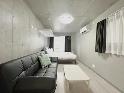 a living room with a couch and a bed at Hotel \u30de\u30fc\u30d9\u30e9\u30b9Asakusa #1 in Tokyo
