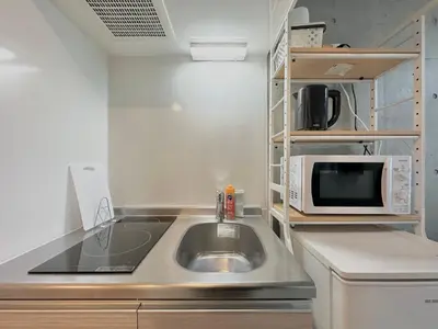 a kitchen with a sink and a microwave at Hotel \u30de\u30fc\u30d9\u30e9\u30b9Asakusa #1 in Tokyo