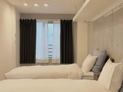 a hotel room with two beds and a window at Hotel \u30de\u30fc\u30d9\u30e9\u30b9Asakusa#LOFT#2 in Tokyo
