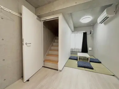 a room with stairs and a chair and a door at Hotel \u30de\u30fc\u30d9\u30e9\u30b9Asakusa#LOFT#2 in Tokyo