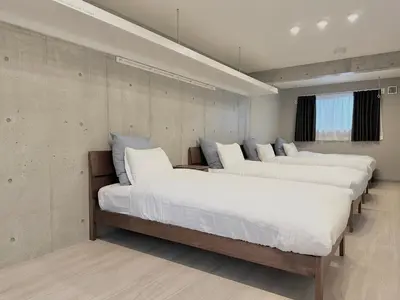 two beds in a room with white sheets at Hotel \u30de\u30fc\u30d9\u30e9\u30b9Asakusa#LOFT#2 in Tokyo