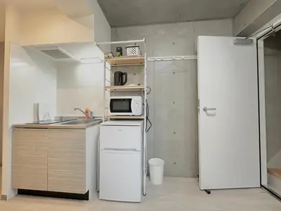 a kitchen with a white refrigerator and a microwave at Hotel \u30de\u30fc\u30d9\u30e9\u30b9Asakusa#LOFT#2 in Tokyo