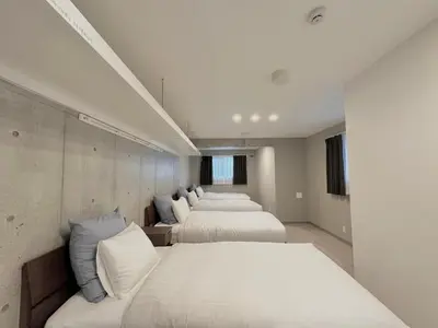 two beds in a room with white walls at Hotel \u30de\u30fc\u30d9\u30e9\u30b9Asakusa#LOFT#2 in Tokyo