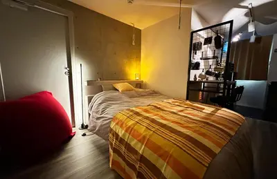 a bedroom with a bed in a room at Caesar House Connecting Room 201and202 in Tokyo