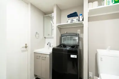 a small bathroom with a sink and a microwave at Caesar House Connecting Room 201and202 in Tokyo