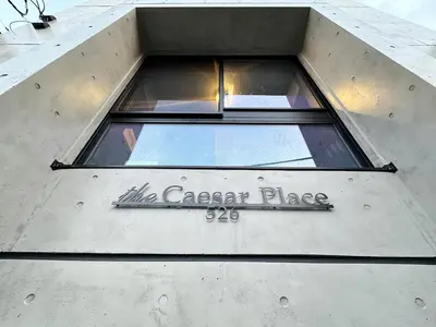 a window on a building with a sign on it at Caesar House Connecting Room 201and202 in Tokyo
