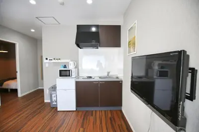 a small kitchen with a tv in a room at QU102 Edogawa Japanese Style Apartment 102 has direct access to Akihabara and Shinjuku, with convenient transportation and free WiFi in Tokyo