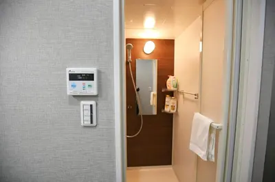 a small bathroom with a shower and a toilet at QU102 Edogawa Japanese Style Apartment 102 has direct access to Akihabara and Shinjuku, with convenient transportation and free WiFi in Tokyo