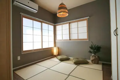 a living room with two windows and a large rug at QU102 Edogawa Japanese Style Apartment 102 has direct access to Akihabara and Shinjuku, with convenient transportation and free WiFi in Tokyo