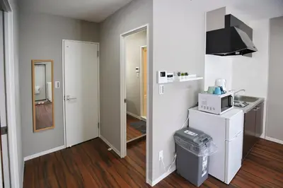 a room with a kitchen with a sink and a refrigerator at QU102 Edogawa Japanese Style Apartment 102 has direct access to Akihabara and Shinjuku, with convenient transportation and free WiFi in Tokyo