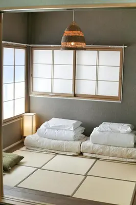 a bedroom with two beds and a chandelier at QU102 Edogawa Japanese Style Apartment 102 has direct access to Akihabara and Shinjuku, with convenient transportation and free WiFi in Tokyo