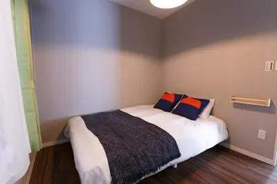 a bedroom with a bed with two pillows on it at QU102 Edogawa Japanese Style Apartment 102 has direct access to Akihabara and Shinjuku, with convenient transportation and free WiFi in Tokyo
