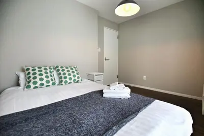 a bedroom with a bed with green and white pillows at QU202 Edogawa Japanese Style Apartment 202 has direct access to Akihabara and Shinjuku, with convenient transportation and free WiFi in Tokyo