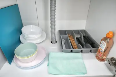a kitchen with plates and utensils on a counter at QU202 Edogawa Japanese Style Apartment 202 has direct access to Akihabara and Shinjuku, with convenient transportation and free WiFi in Tokyo