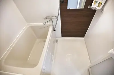 a white bath tub in a small bathroom at QU202 Edogawa Japanese Style Apartment 202 has direct access to Akihabara and Shinjuku, with convenient transportation and free WiFi in Tokyo