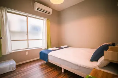 a bedroom with a bed and a large window at QU202 Edogawa Japanese Style Apartment 202 has direct access to Akihabara and Shinjuku, with convenient transportation and free WiFi in Tokyo