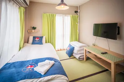 a small room with a bed and a tv at QU202 Edogawa Japanese Style Apartment 202 has direct access to Akihabara and Shinjuku, with convenient transportation and free WiFi in Tokyo