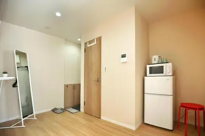 a room with a refrigerator and a microwave at QU301 Edogawa Japanese Style Apartment 301 has direct access to Akihabara and Shinjuku, with convenient transportation and free WiFi in Tokyo