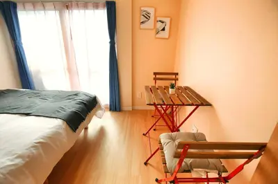 a bedroom with a bed and a table and a chair at QU301 Edogawa Japanese Style Apartment 301 has direct access to Akihabara and Shinjuku, with convenient transportation and free WiFi in Tokyo