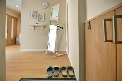 a row of shoes in a room with a mirror at QU301 Edogawa Japanese Style Apartment 301 has direct access to Akihabara and Shinjuku, with convenient transportation and free WiFi in Tokyo