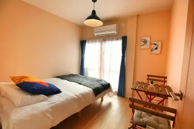 a bedroom with a bed and a window and a table at QU301 Edogawa Japanese Style Apartment 301 has direct access to Akihabara and Shinjuku, with convenient transportation and free WiFi in Tokyo