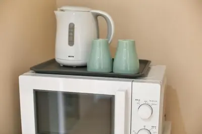 a microwave with three cups and a blender on top of it at QU301 Edogawa Japanese Style Apartment 301 has direct access to Akihabara and Shinjuku, with convenient transportation and free WiFi in Tokyo